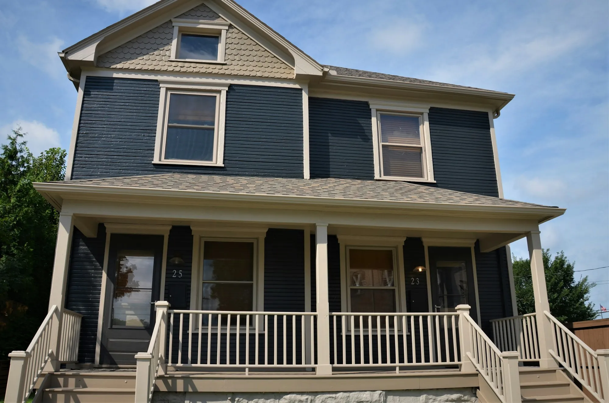 Blue two-story house with a covered front porch